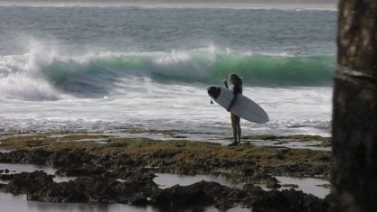 Surfer waiting on a reef